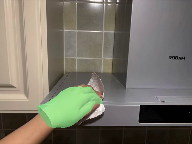 Wipe the range hood with the paper towel
